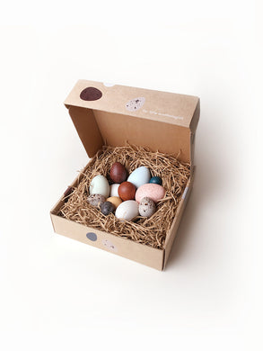 A dozen bird eggs in a box